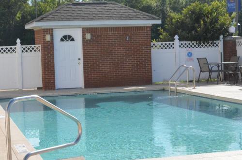 a small swimming pool with a gazebo at Home Inn & Suites in Montgomery
