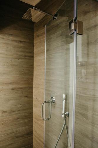 a shower with a glass door in a bathroom at Casa Roaz in Setúbal