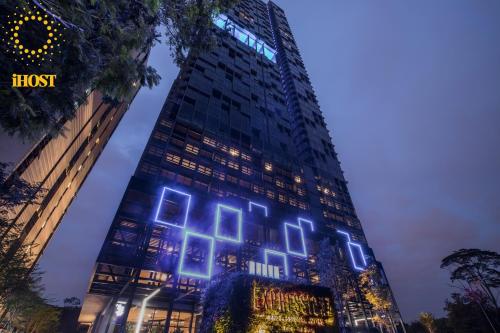 a tall building with blue lights on it at Expressionz Suites By iHost Global in Kuala Lumpur