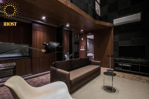 a living room with a couch and a tv at Expressionz Suites By iHost Global in Kuala Lumpur