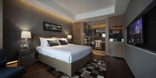 a hotel room with a bed and a television at Bloom Boutique Hotel in Chongqing
