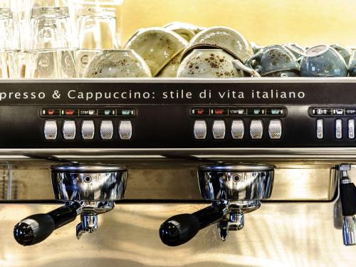 a counter with plates and bowls on top at Mercure München City Center in Munich