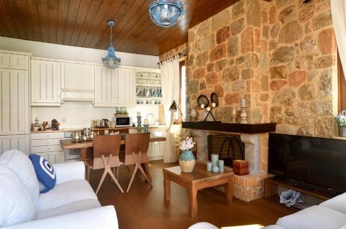 a kitchen and living room with a stone wall at Nafplio Place in Nafplio