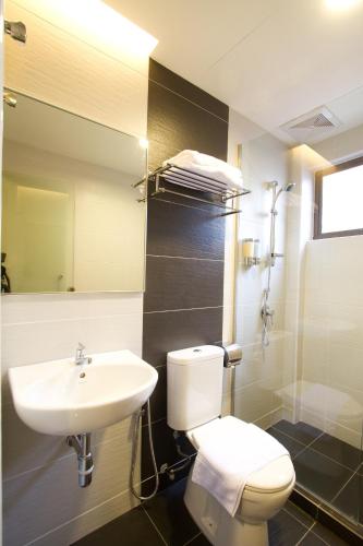 a bathroom with a white toilet and a sink at Lotus Hotel Masjid India in Kuala Lumpur