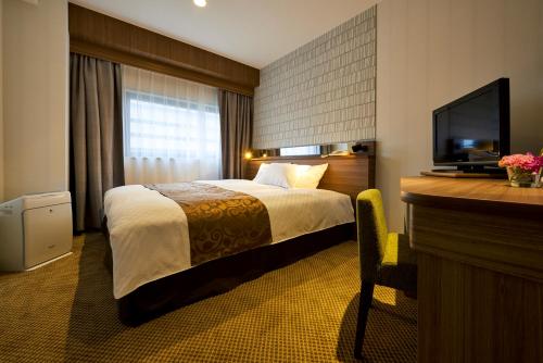 Posteľ alebo postele v izbe v ubytovaní Sendai Kokusai Hotel