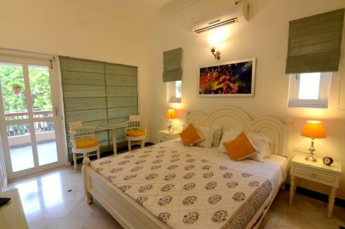 a bedroom with a large bed and a balcony at Aashray Homestay in Varanasi