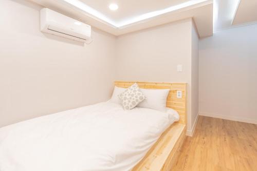 a bedroom with a white bed in a room at Dawoo House 1 in Hongdae in Seoul
