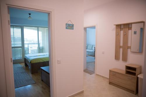 a room with a bedroom with a bed and a mirror at Sonia Apartment in St. St. Constantine and Helena