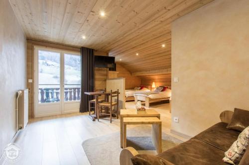 a living room with a couch and a table at Auberge Du Fraizier in Thônes