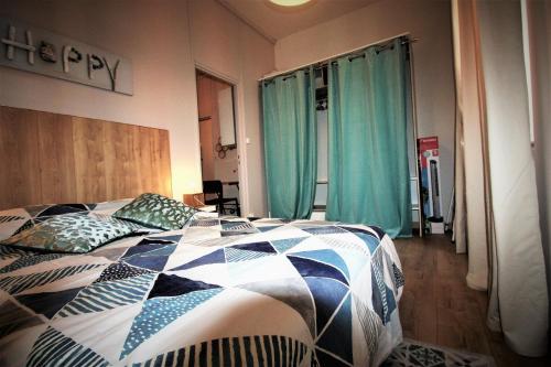 1 dormitorio con 1 cama con edredón en Escale meublée en Belfort