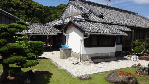 a small white house with a black roof at 玉の浦sea in Nachikatsuura