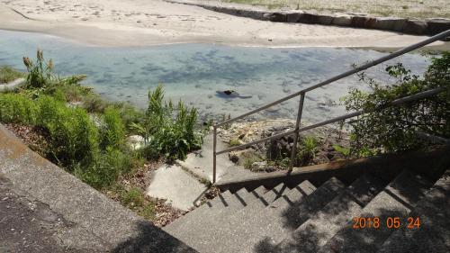 a set of stairs leading to a pool of water at 玉の浦sea in Nachikatsuura