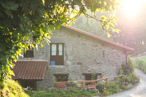 a small stone building with a window and a roof at Otardi in Asteasu