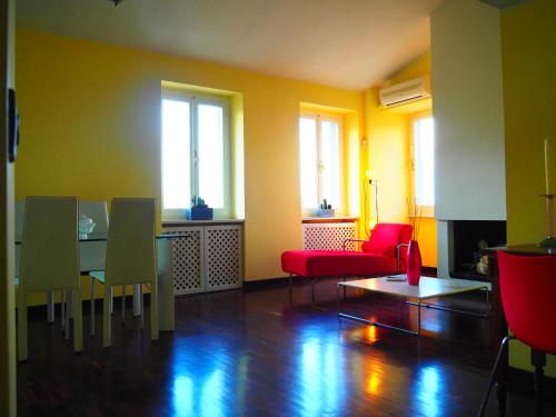 a living room with a table and chairs and windows at trompe l'oeil in Perugia