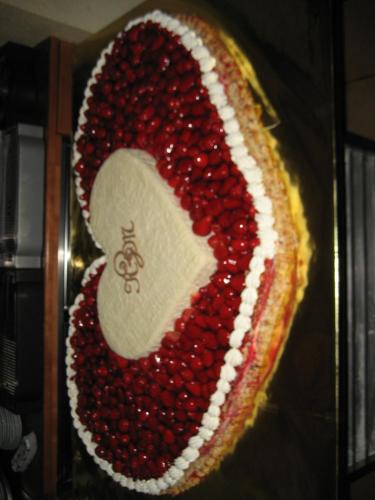 a red and white cake with a letter s on it at Cafe-Konditorei-Pension Sander in Niederfell