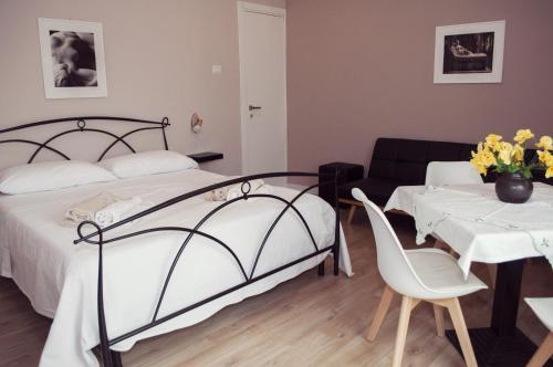 a bedroom with a bed and a table and a couch at Casa Giulia in Cagliari