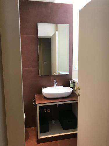 a bathroom with a sink and a mirror at Luigi in Palazzo Bianchi in Parma
