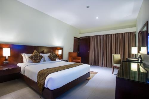 Säng eller sängar i ett rum på Hotel Grand Park Barishal