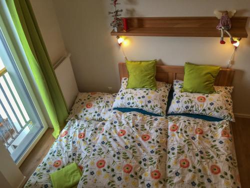 a bedroom with two beds with green pillows at KUBO TATRY - Starý Smokovec in Smokovce