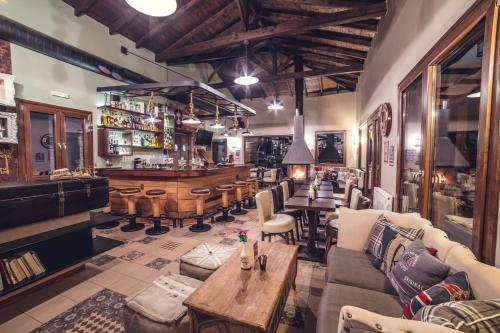 a bar with couches and tables in a room at Paroraia in Angistron