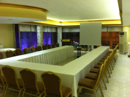 a long table in a room with chairs at Hotel Artiç in Bursa