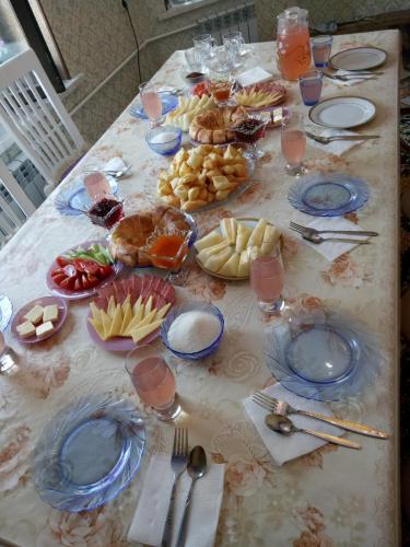 a table with plates of food on top of it at Kurak Homestay in Bishkek