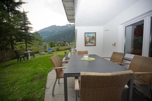 a table and chairs on a patio with a view at AlpinDesign Kaunertal in Kaunertal