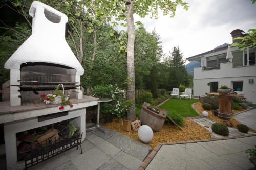 a backyard with a fireplace with snow on top of it at AlpinDesign Kaunertal in Kaunertal