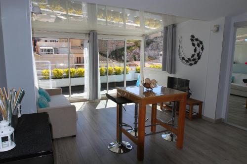 a living room with a table and a large window at La Terrasse du Pecheur in Marseille