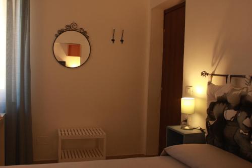 a bedroom with a mirror and a bed at Casa Madè in Chieti