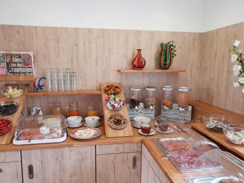 a kitchen with lots of food on a counter at Hotel Weisser Hof in Malente