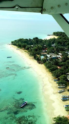 an aerial view of a beach with boats in the water at Paraiso Beach Hotel in Big Corn Island
