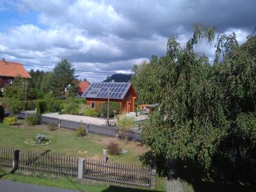 a house with a solar panel on the roof at Pension Edelweiß in Kurort Gohrisch