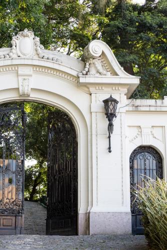 an entrance to a white building with a black gate at Vila Santa Teresa in Rio de Janeiro