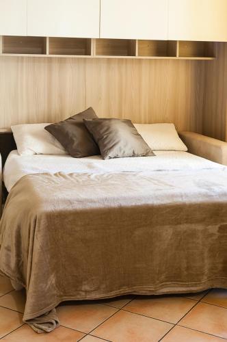 a bed with two pillows on top of it at Casa Nocchi in Lucca
