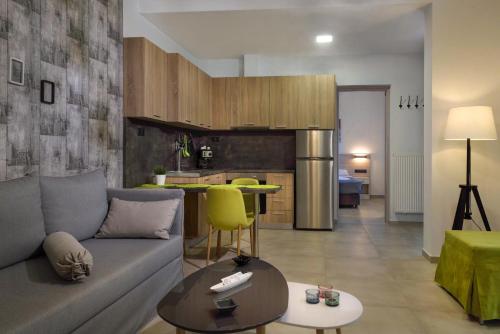 a living room with a couch and a kitchen at Νautilus luxury apartments in Ierissos
