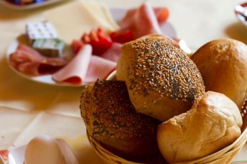 a basket of bread and eggs and fruit on a table at Bistro im Ring in Quiddelbach