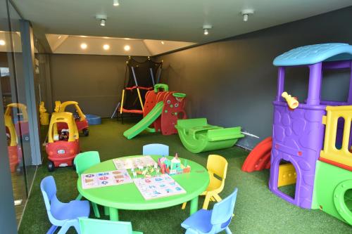 a play room with a table and play equipment at Brightland Resort & Spa in Mahabaleshwar