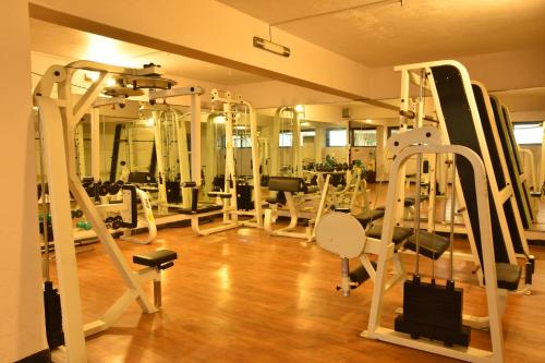 a gym with a bunch of treadmills and machines at Brightland Resort & Spa in Mahabaleshwar