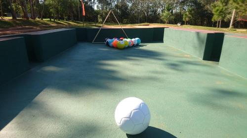 a soccer ball sitting on a playground with a soccer ball at El Paraje Camping in Piribebuy