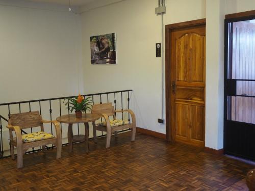 a room with a table and two chairs and a door at Boonnark Bed Night Bazaar no car parking in Chiang Mai