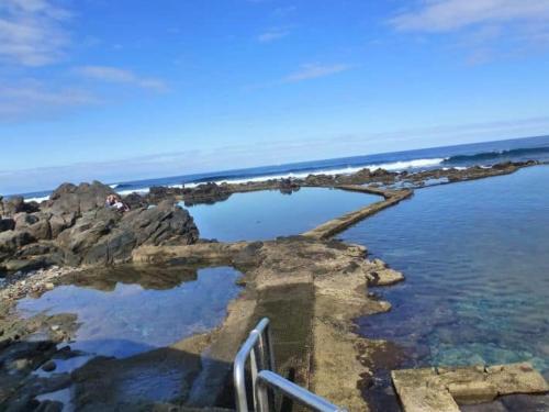 a pool of water on the rocks near the ocean at Casa Avenida del Agujero in Gáldar