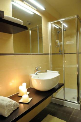 a bathroom with a sink and a glass shower at Residence Belmare in Rimini