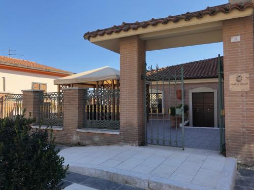 a brick house with a gate in front of it at Luxury B&B Dimora Albani in Savignano Irpino
