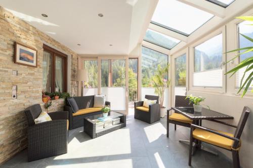 a living room with glass ceilings and windows at Das Elisabeth in Sankt Anton am Arlberg