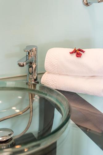 a glass table with a faucet in a bathroom at Quinta da Paz B&B in Portimão