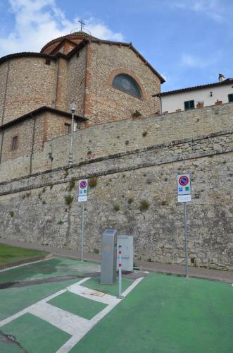 a large brick building with two signs in front of it at Il Torrione in Castiglione del Lago