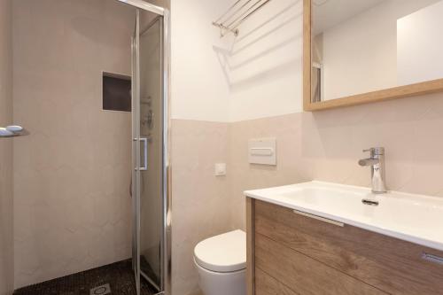 a bathroom with a toilet and a sink and a shower at Gava Mar- Castelldefels Beachfront Apartment- Direct access to the beach in Gavà