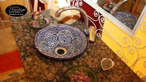 a bathroom sink with a blue and white pattern on it at Karim Sahara Prestige in Zagora