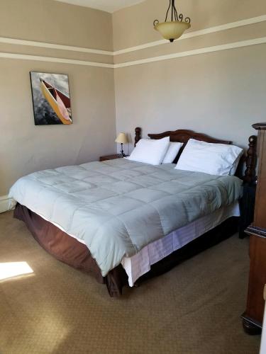 a bedroom with a large bed with white pillows at The Westland Suite in Chester